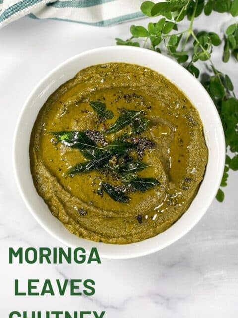 A bowl of moringa leaves chutney is on the table.