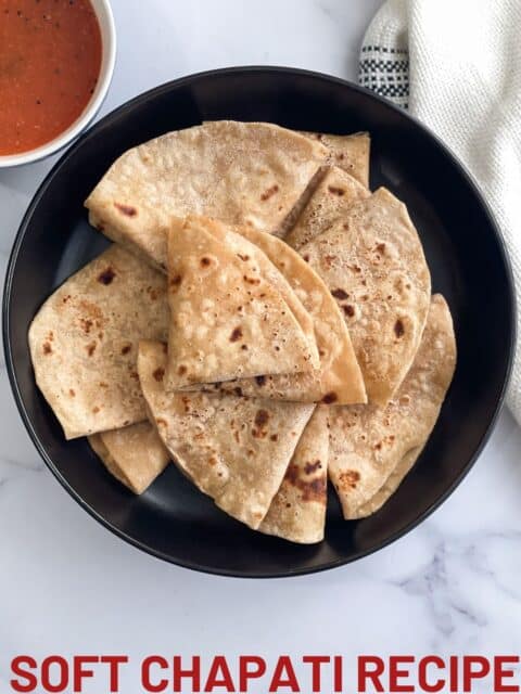 A plate full of folded chapati.