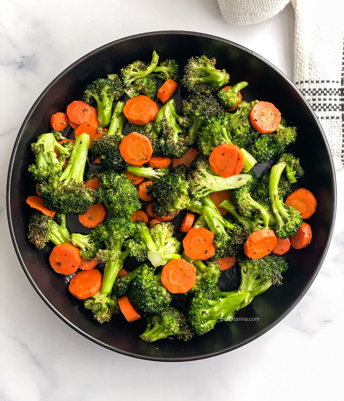 The plate has air fried carrots and broccoli.