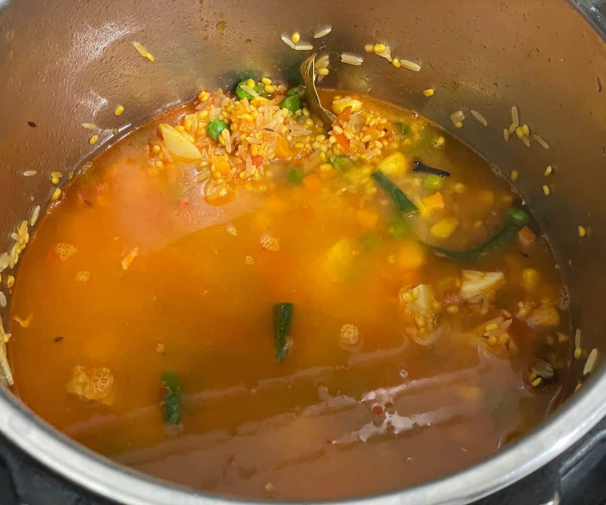 An instant pot is full of moong dal khichdi mixture.