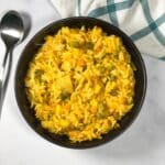 A bowl of Bengali moong dal khichdi is on the surface.
