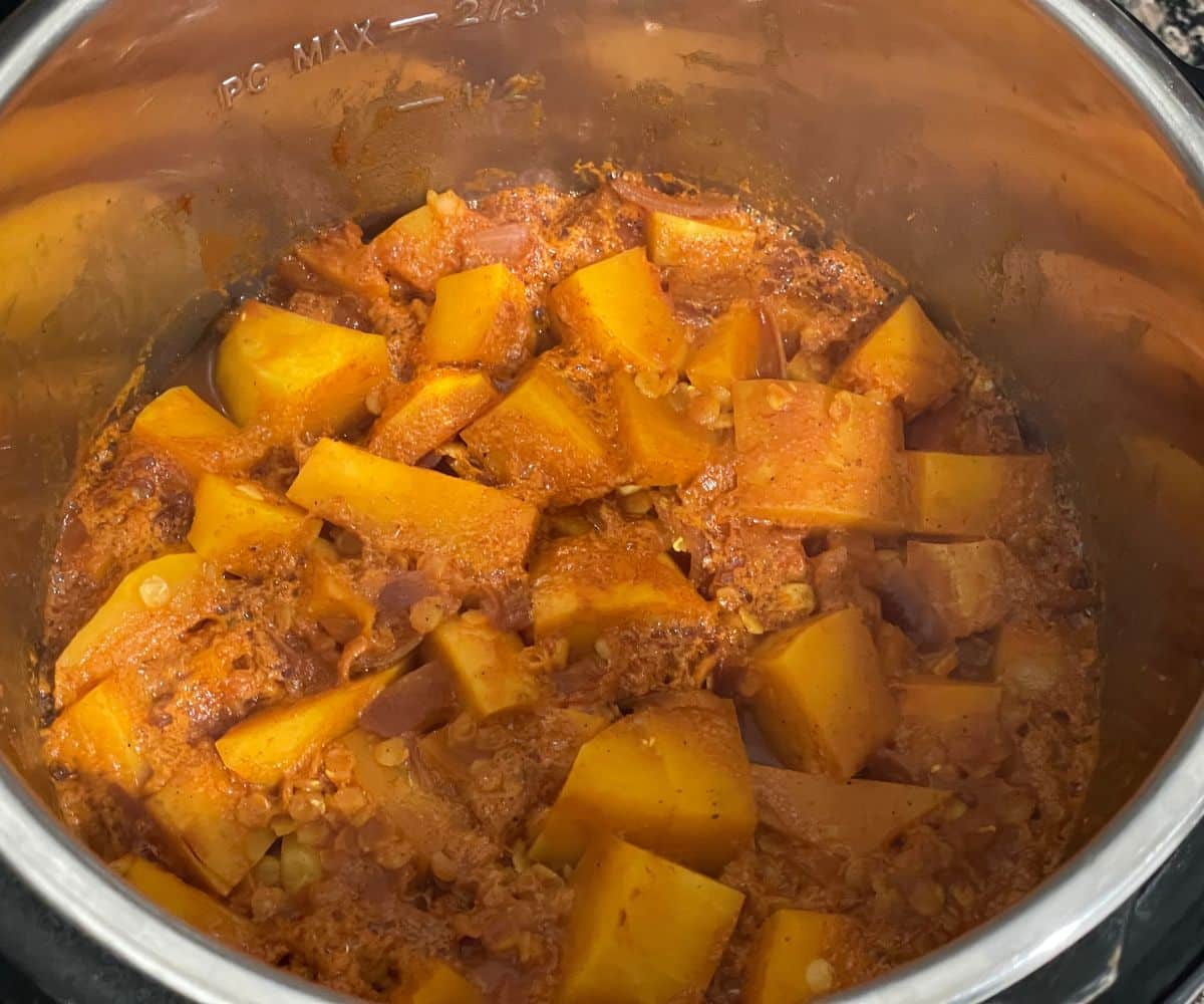 An instant pot has butternut squash curry.