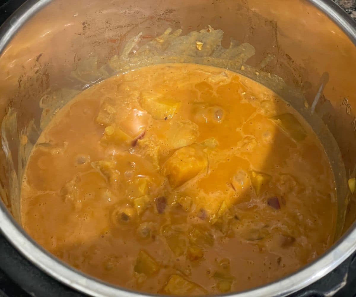 A pot filled with butternut squash lentil curry.