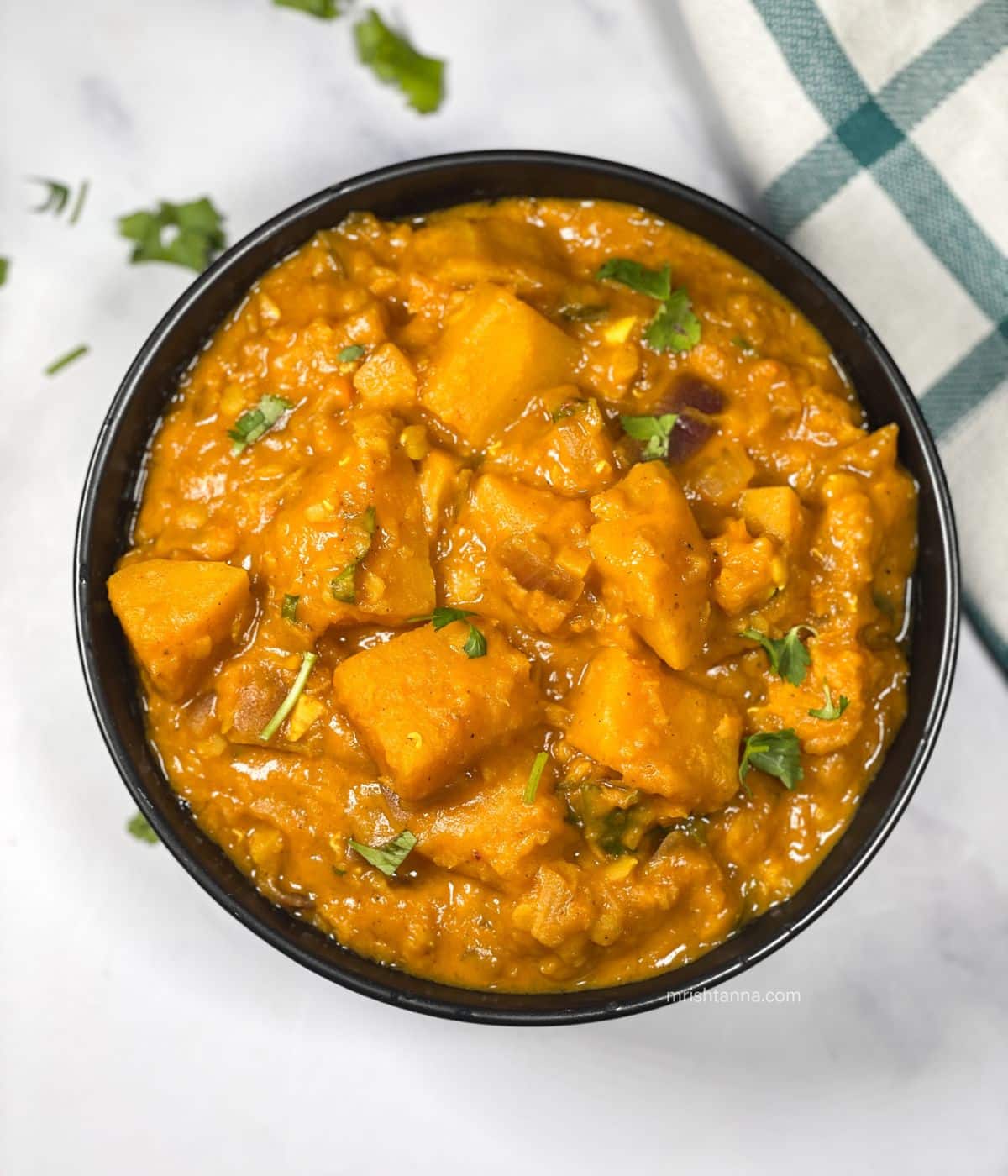 A bowl is filled with instant pot butternut squash curry.