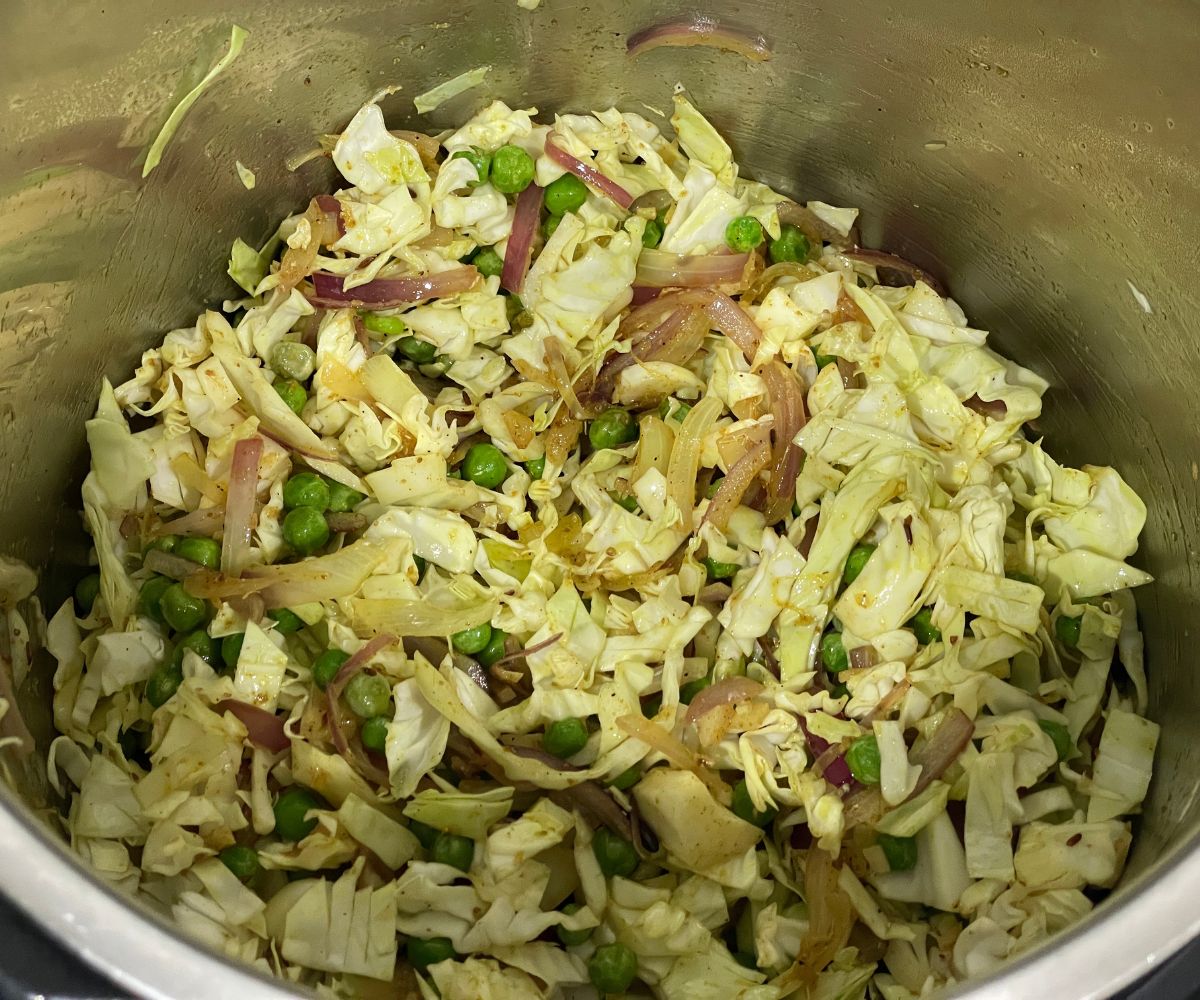 A pot has all the spices and cabbages in cooking mode.