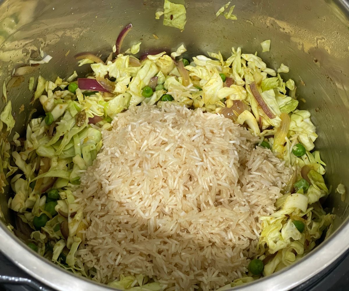 A pot has all the ingredients to make cabbage rice.