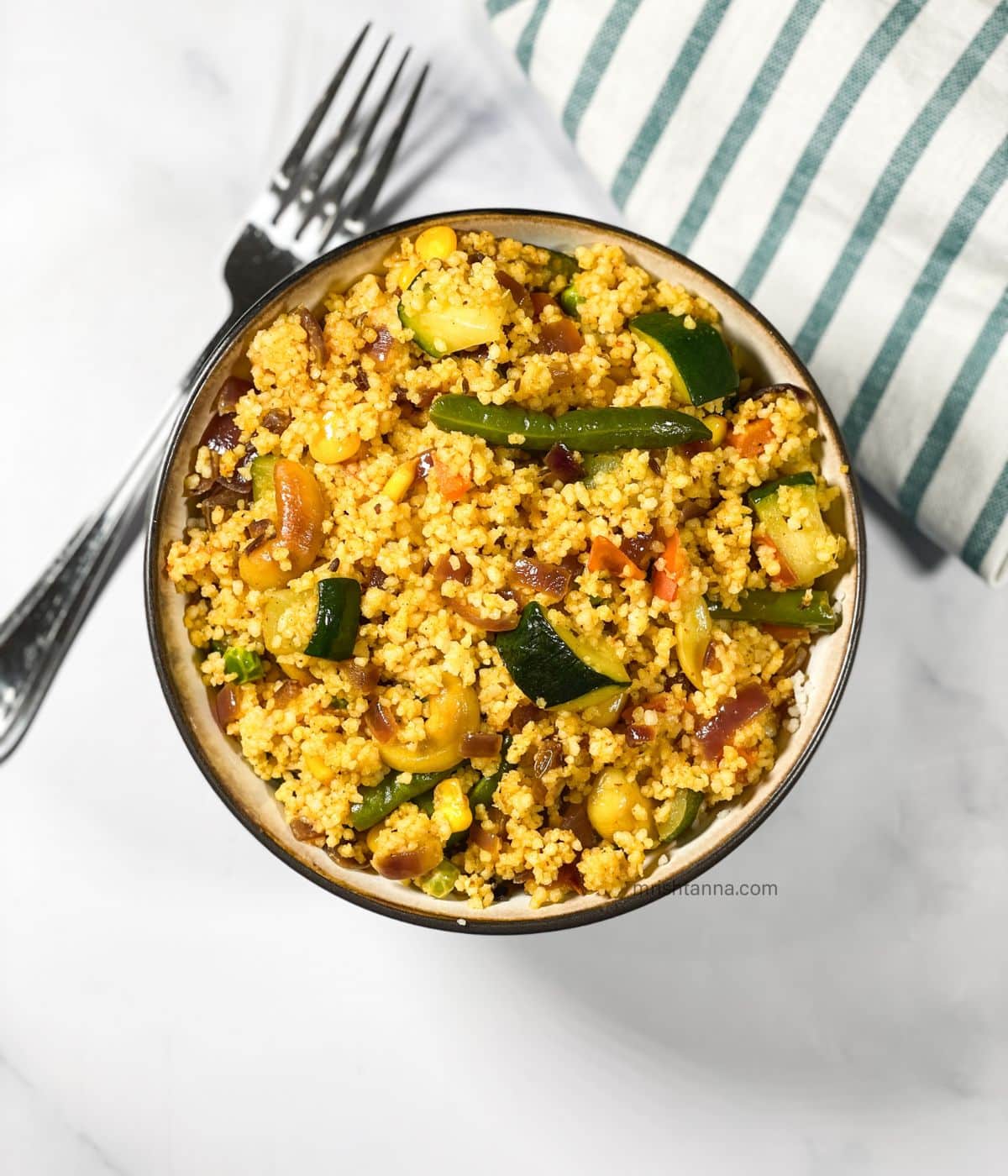 A bowl is full of curried couscous recipe.