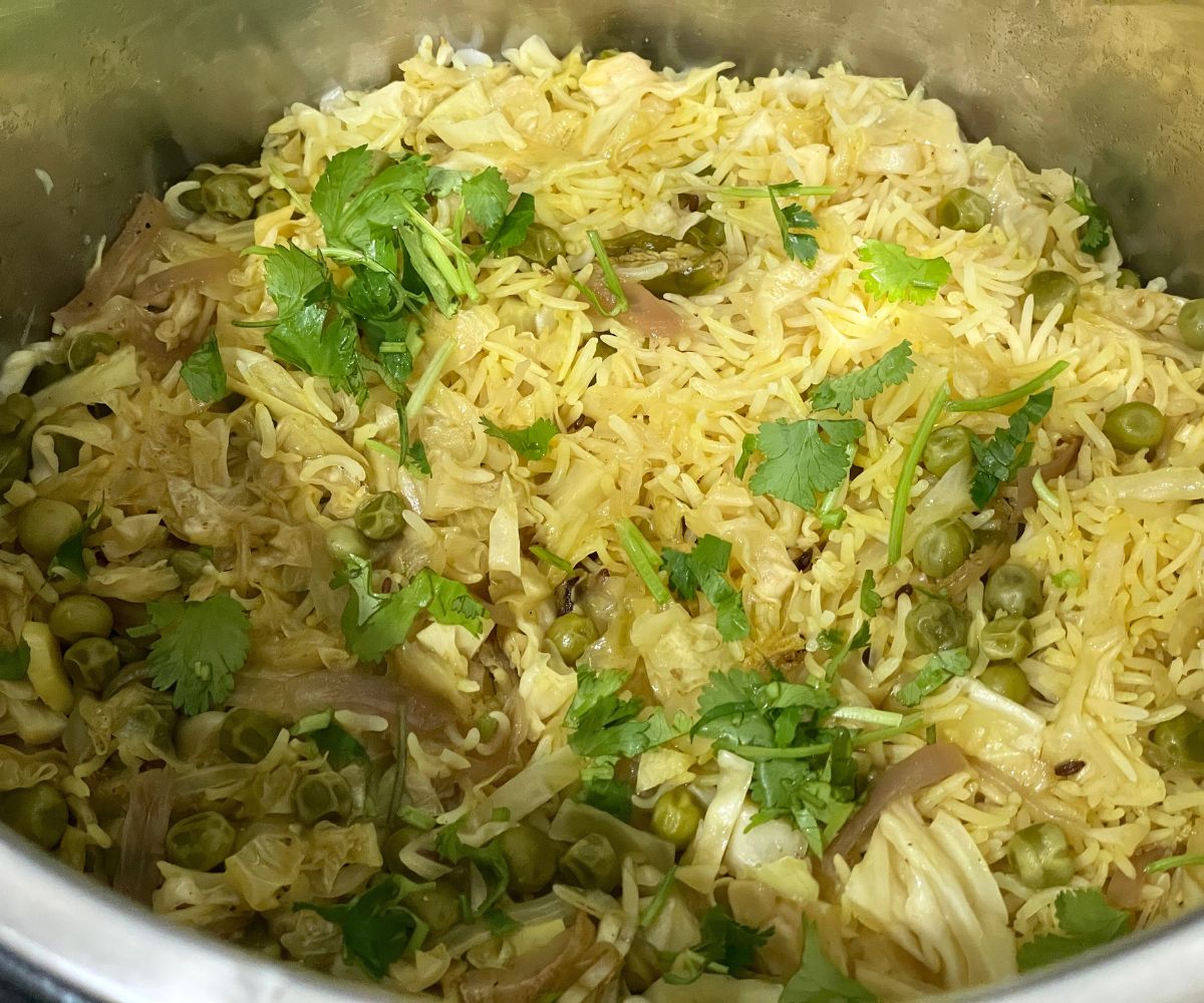 An instant pot has Indian cabbage rice.