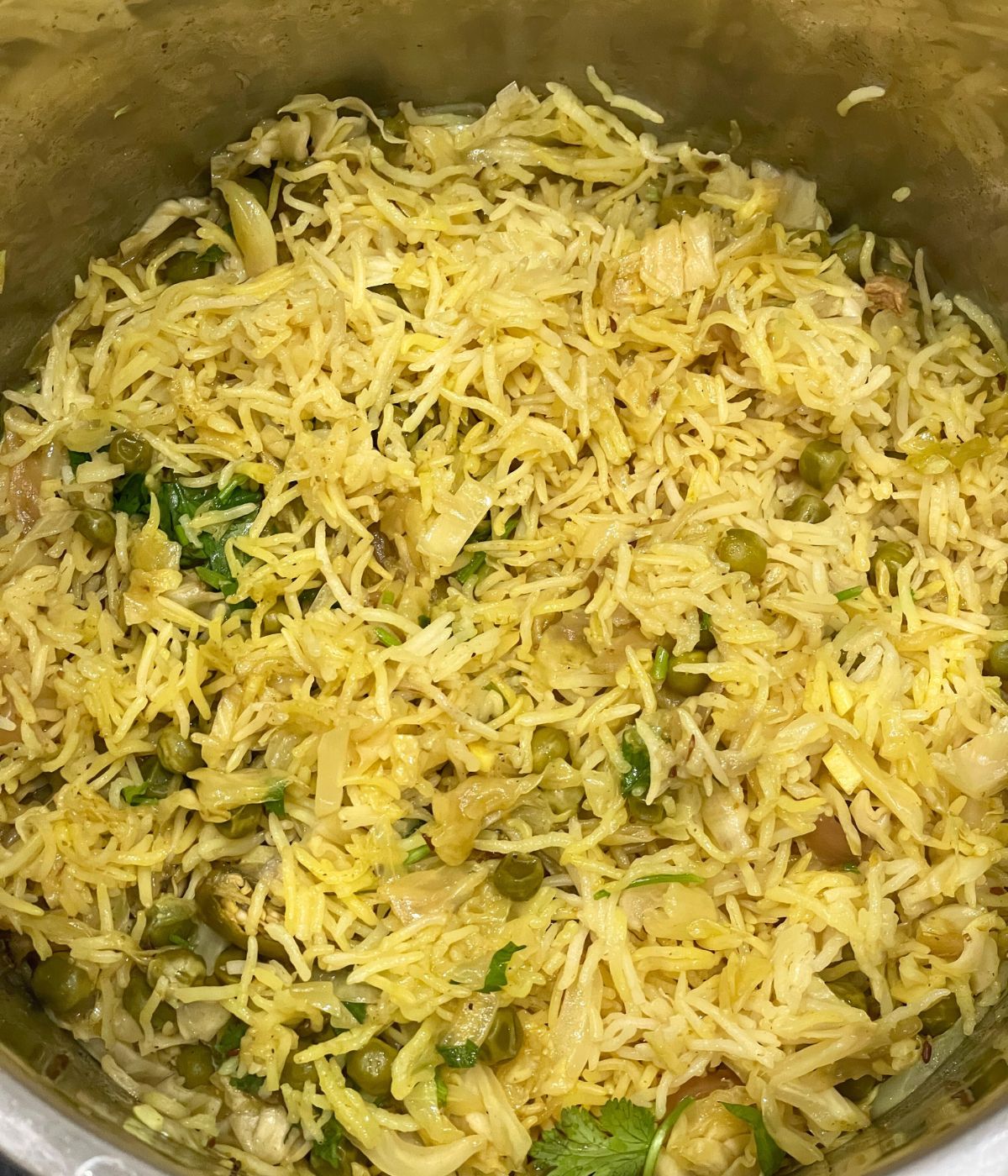 An Instant pot has Indian cabbage rice.