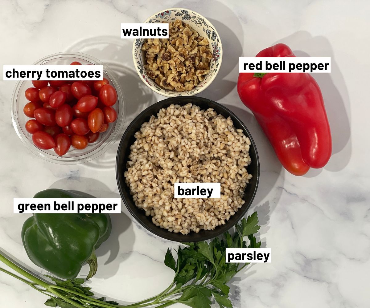 Vegan barley salad ingredients are on the table.