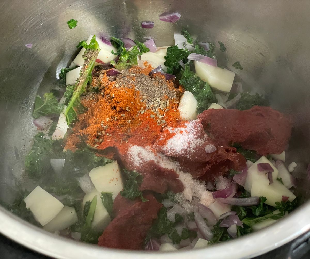 An instant pot has all the veggies and spices for lentil soup.