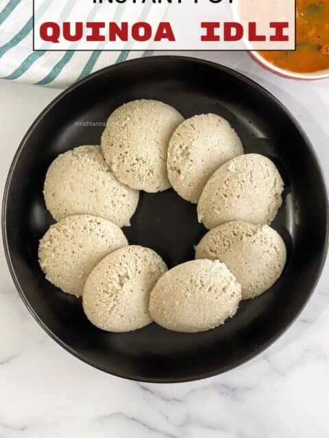 A plate full of quinoa idlis is on the table.