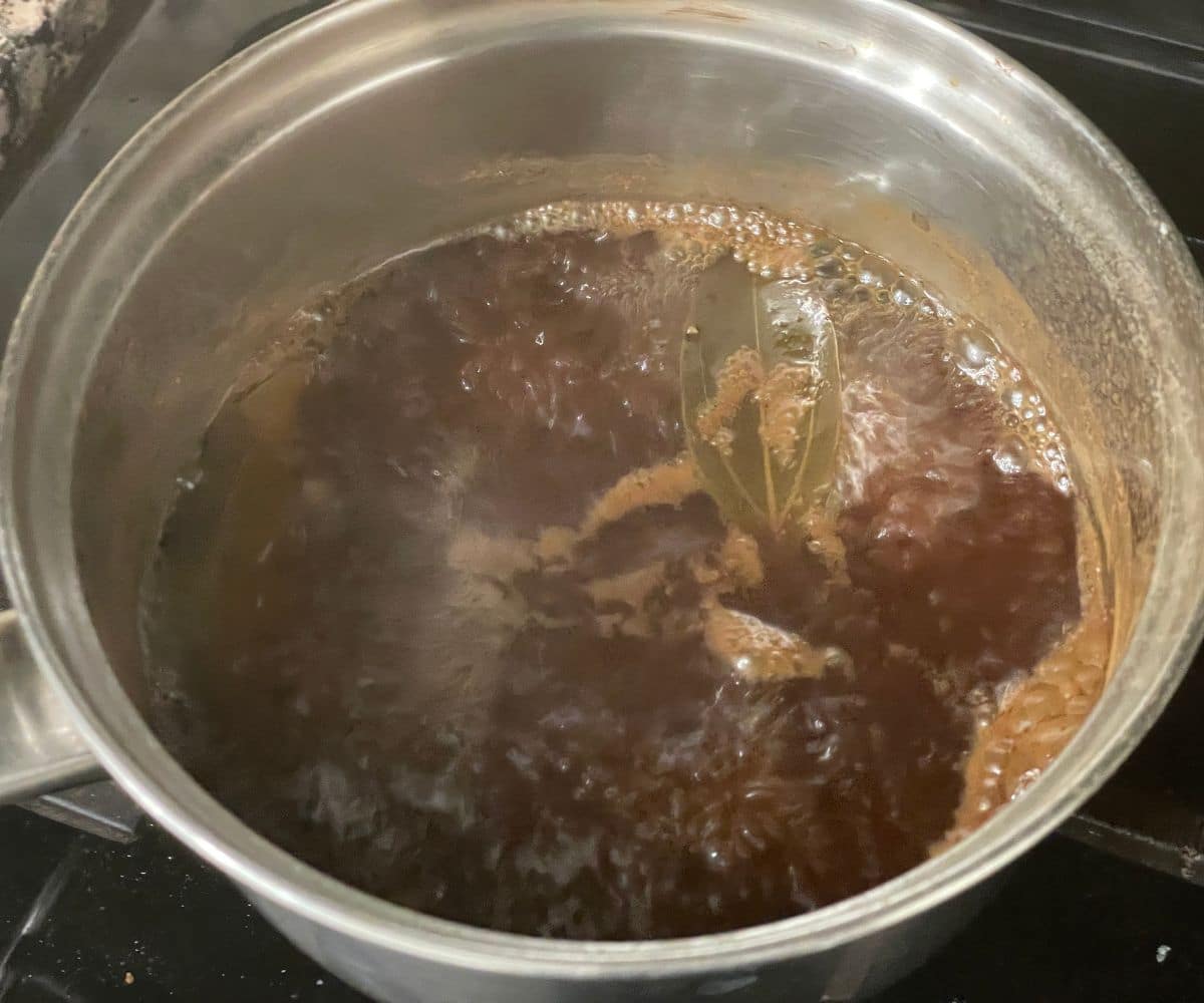 A pot of bay leaf  and cinnamon tea is boiling.