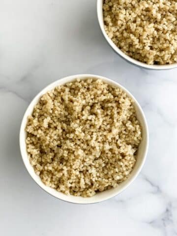 A bowl has cooked quinoa.