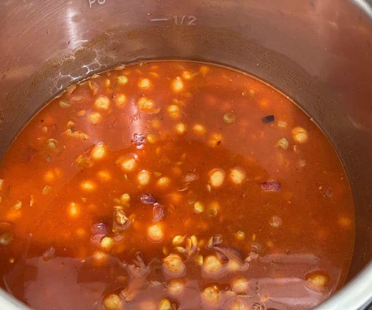 An instant pot has chickpea lentil curry mixture.