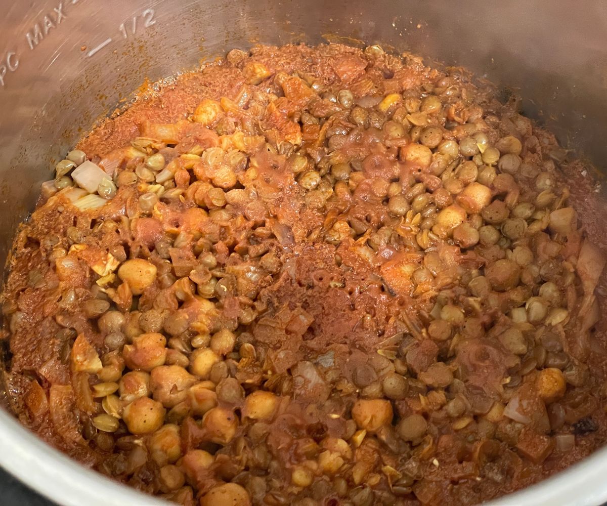 An instant pot has chickpea and lentil curry.