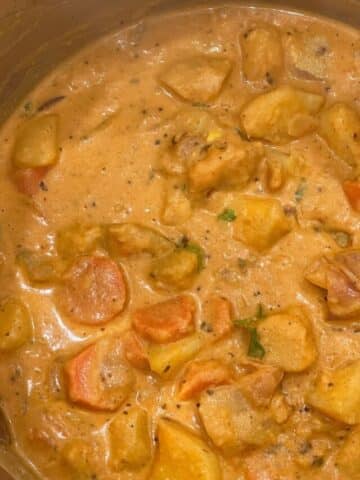 A pot is filled with vegan potato curry.