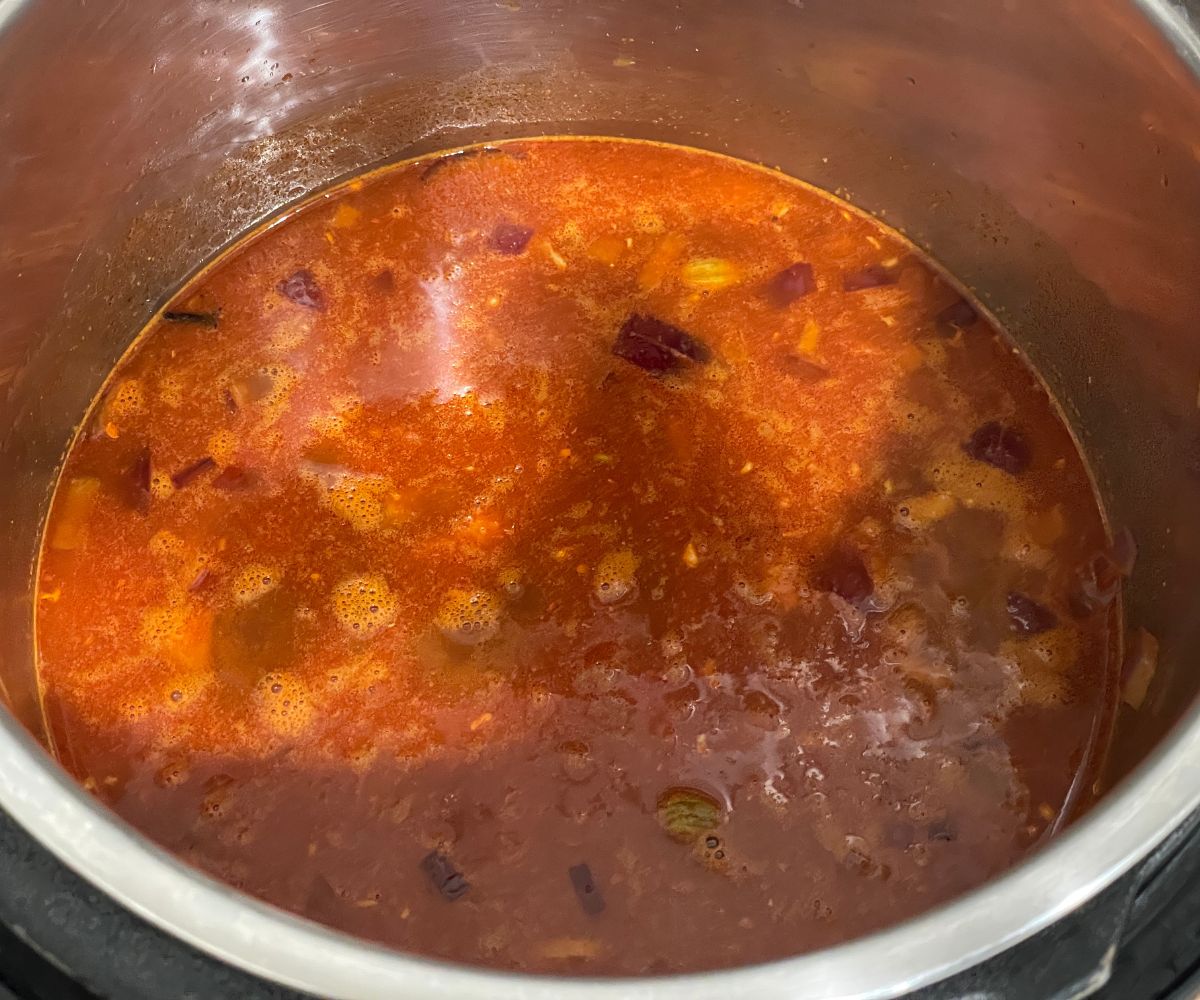 An instant pot has dal makhani mixture.