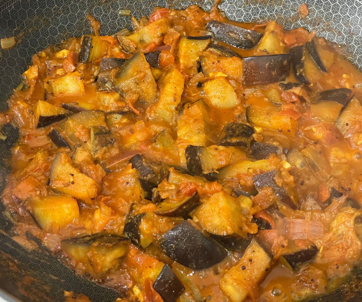 A pan has Indian eggplant masala curry.