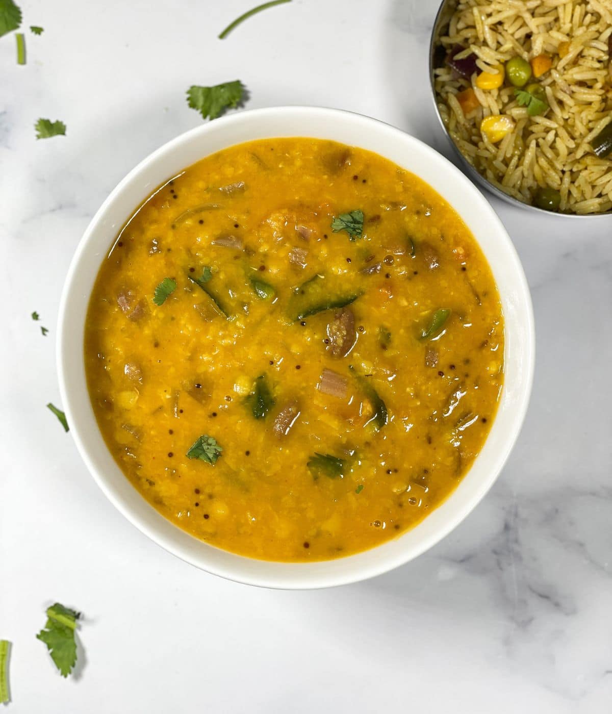 A bowl of gujarati dal is on the table.