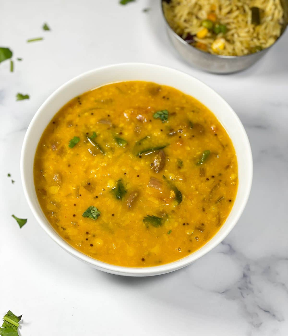 A bowl is full of Gujarati dal.