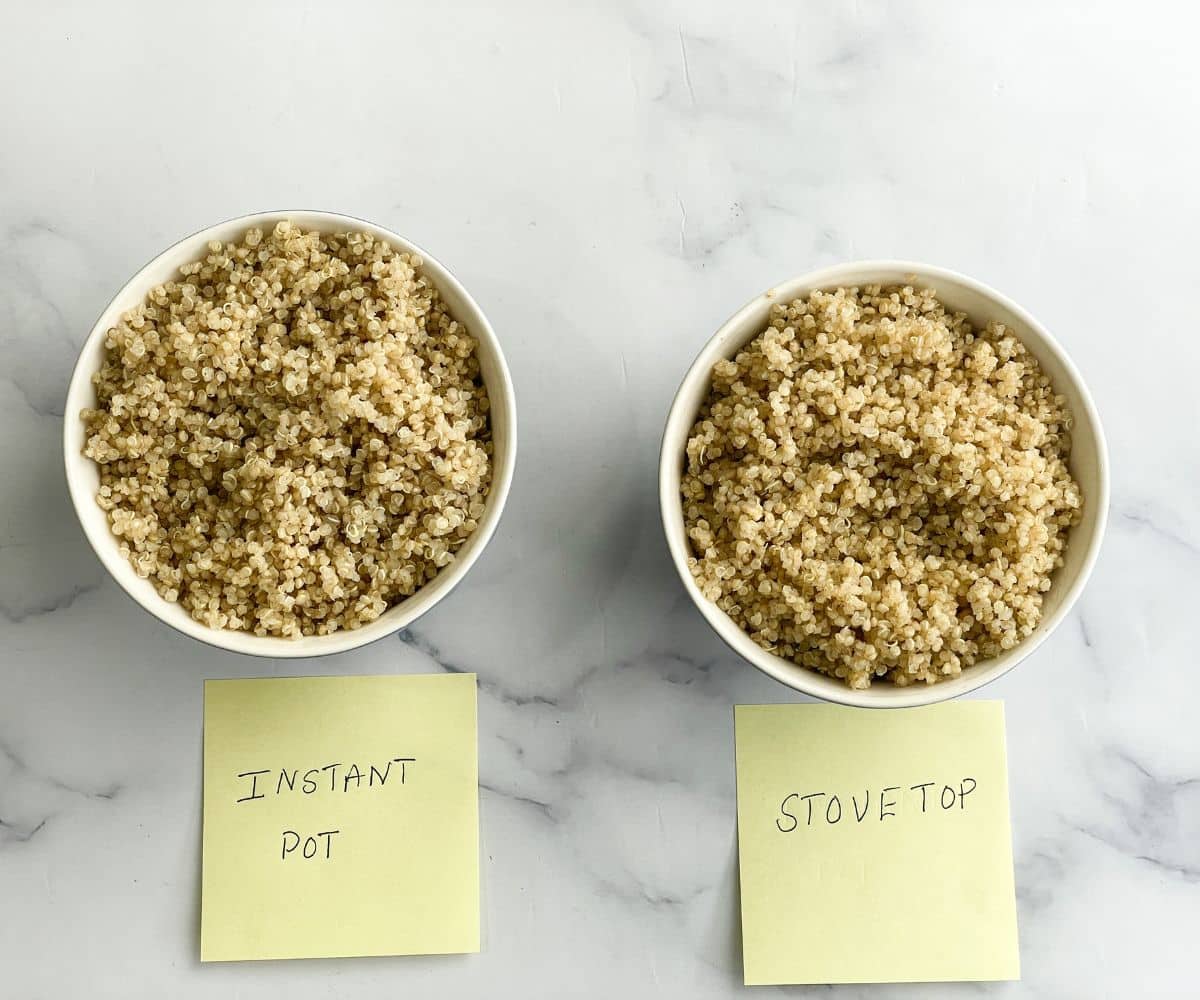 Two bowls have cooked quinoa on the surface.