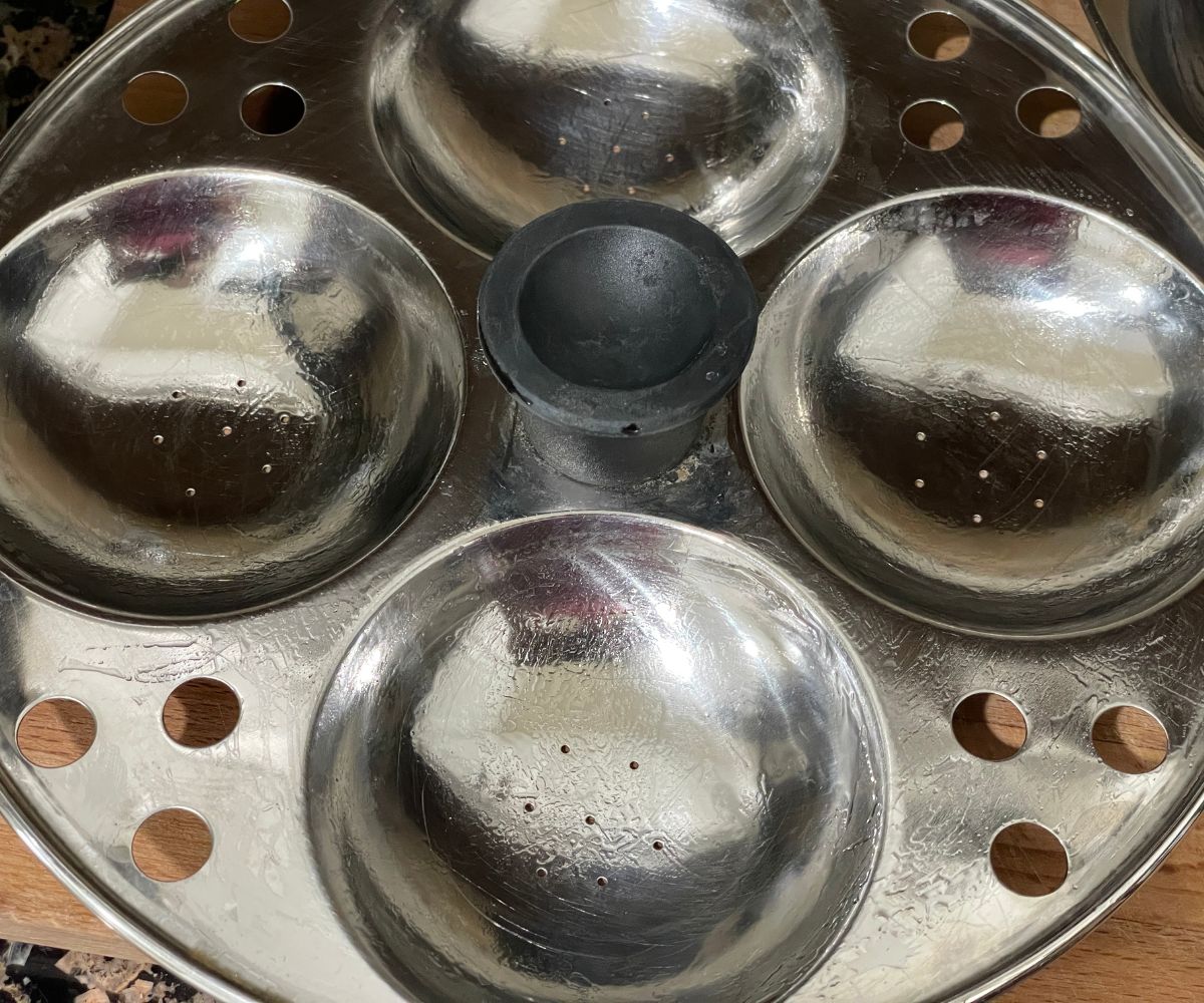 Idli plates are greased with oil.