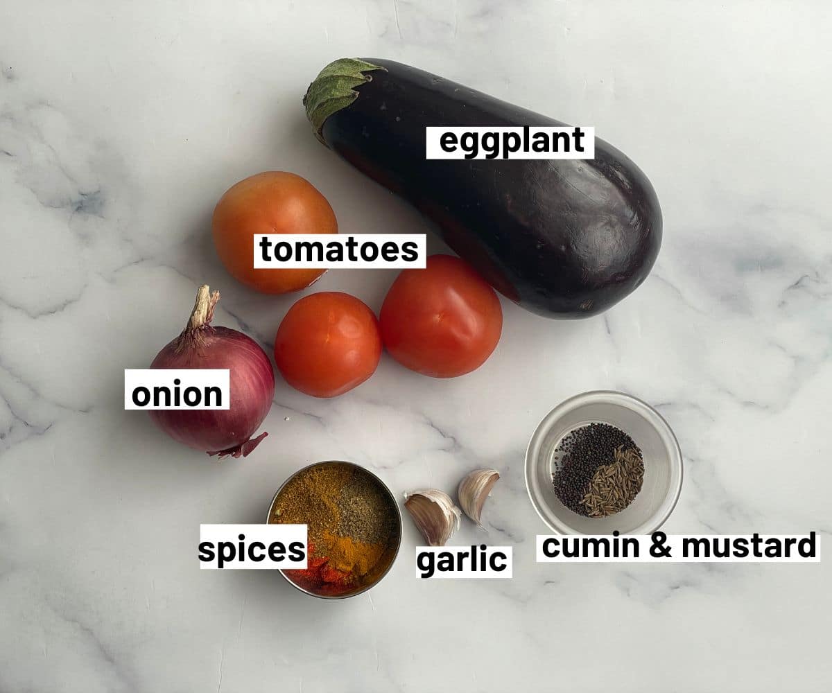 Indian eggplant masala curry ingredients are on the table.