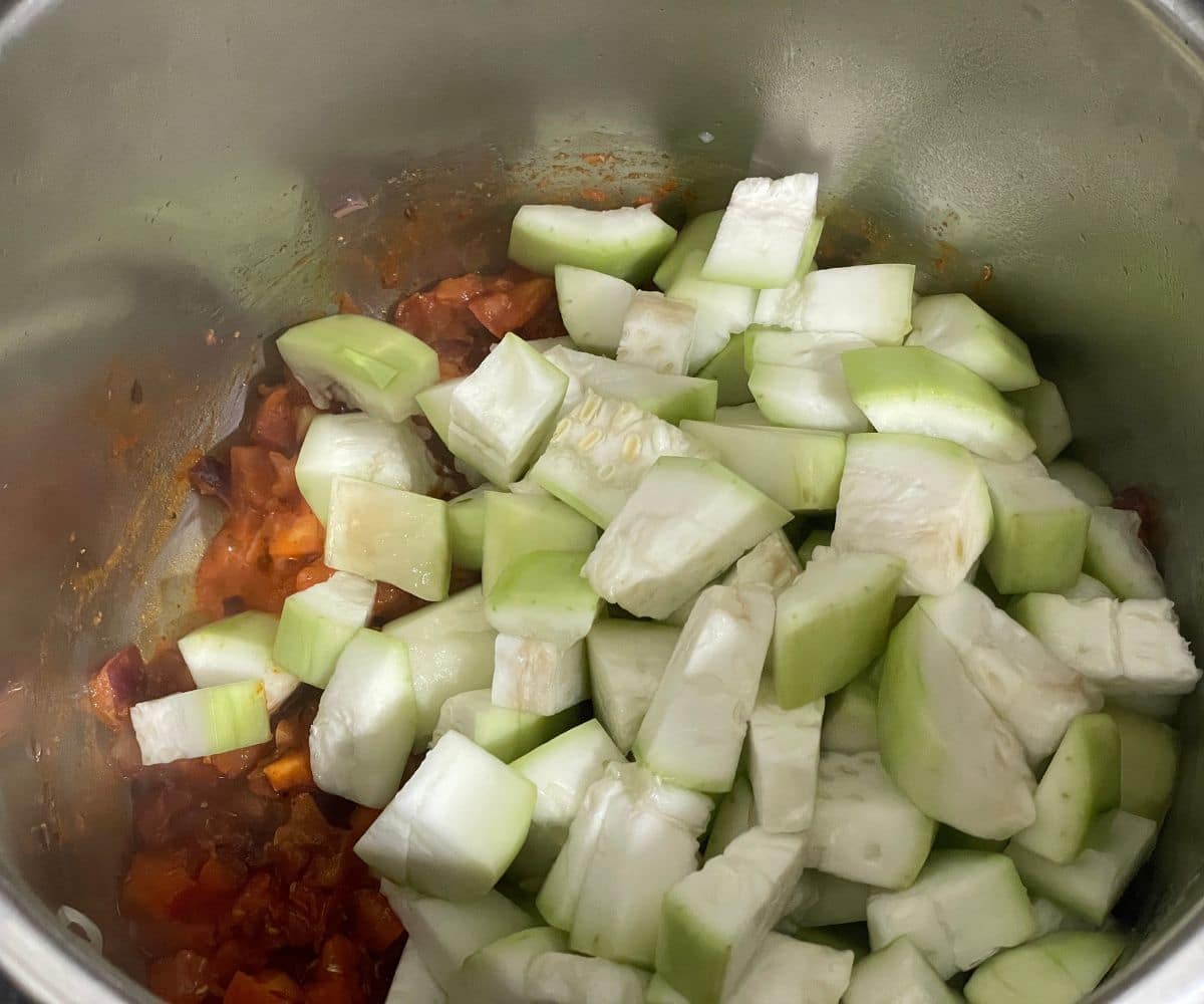 An instant pot has all the lauki sabzi ingredients cooking.