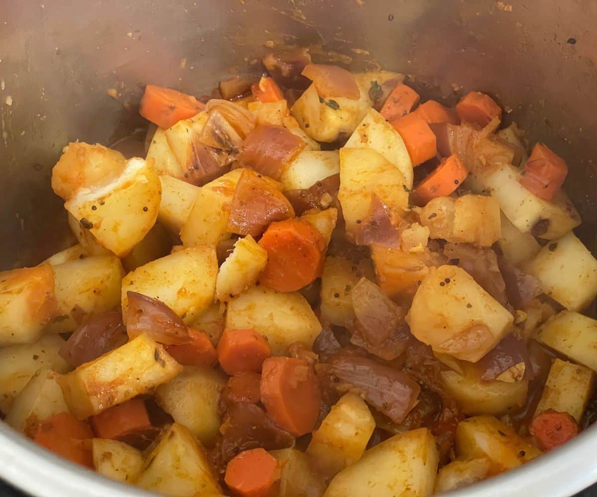 Instant pot is full of cooked potato curry.