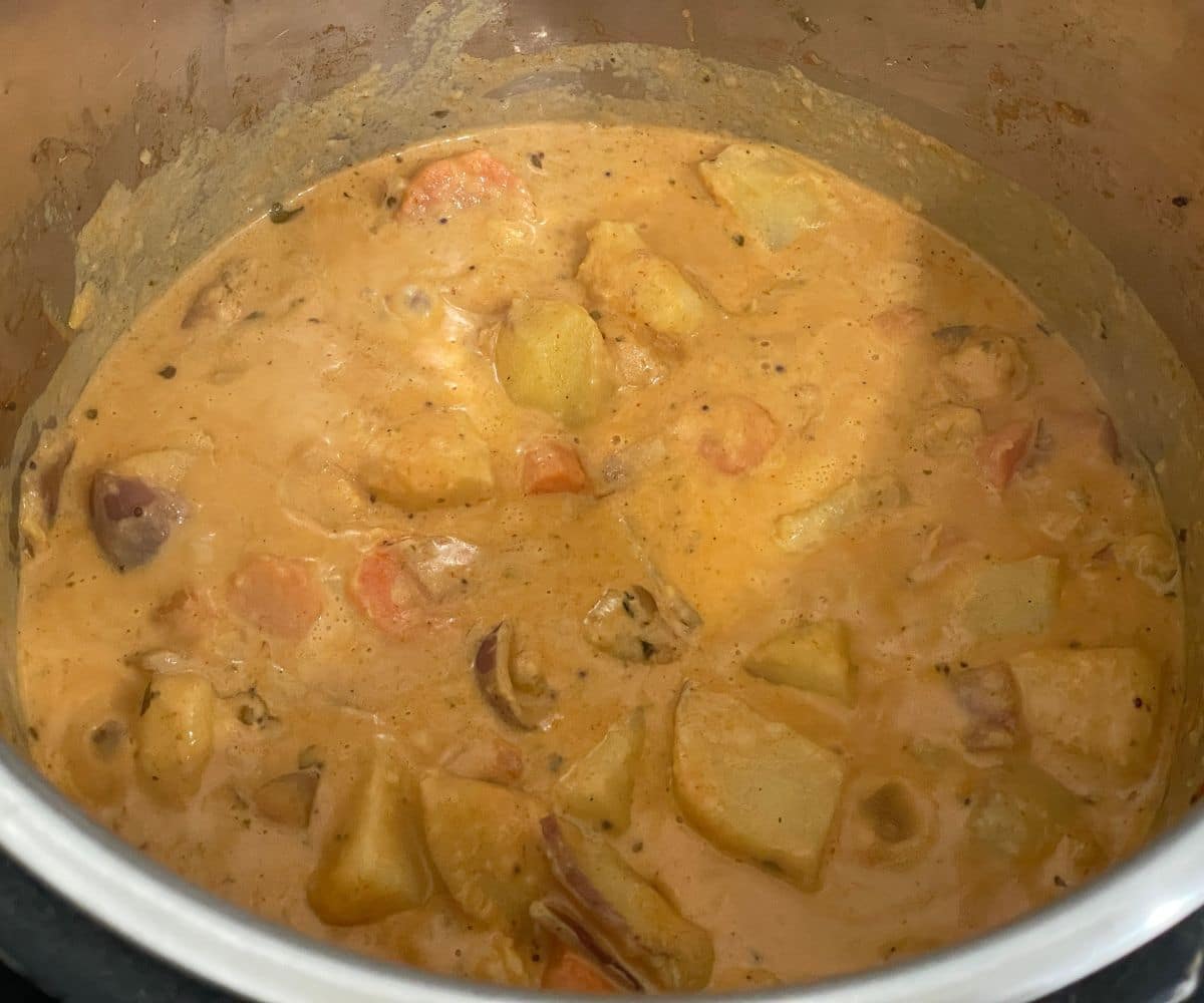 An Instant pot is filled with vegan potato curry.