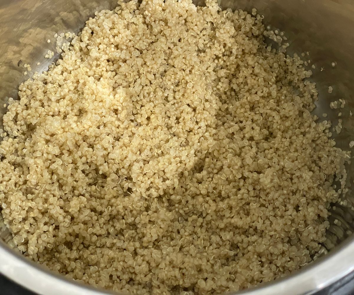 An instant pot has cooked quinoa.