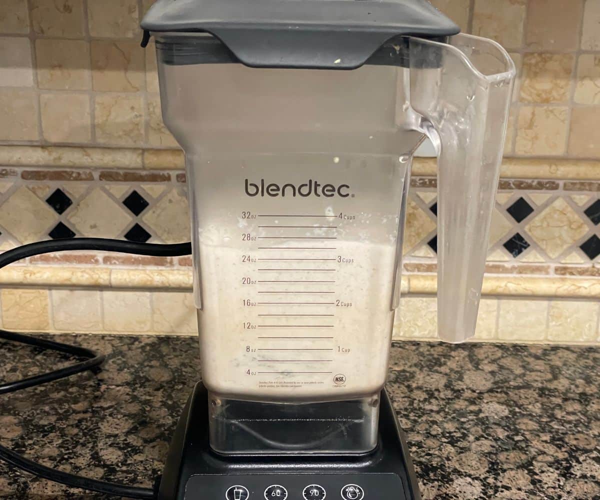 A blender is blending quinoa idli batter.