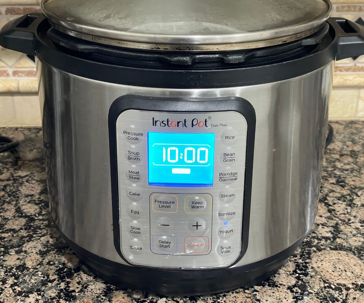 An instant pot showing timer for idli batter.