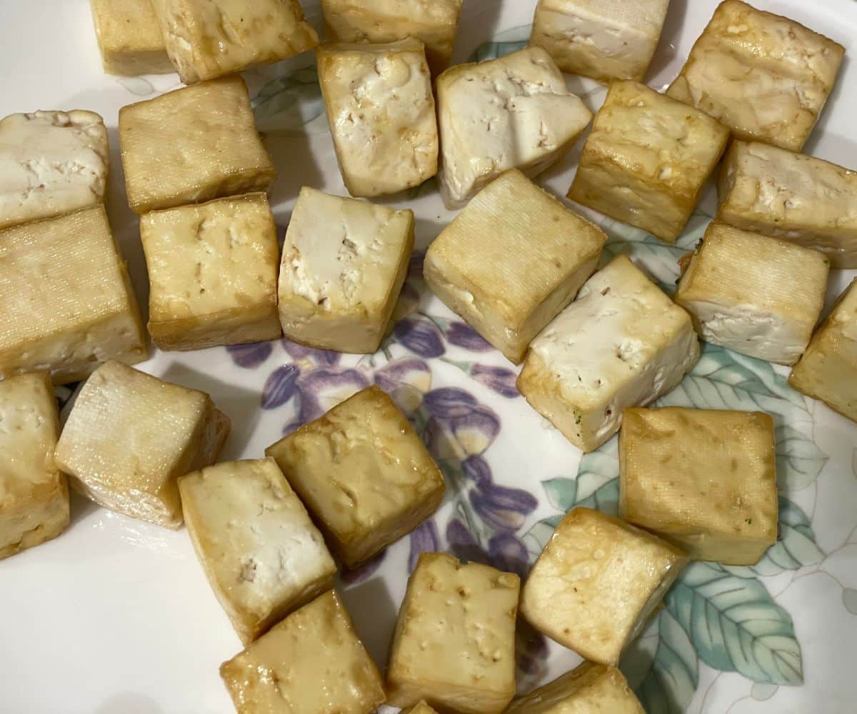 A plate has air fried tofu cubes.