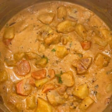 A pot is filled with vegan potato curry.