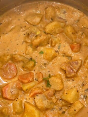 A pot is filled with vegan potato curry.