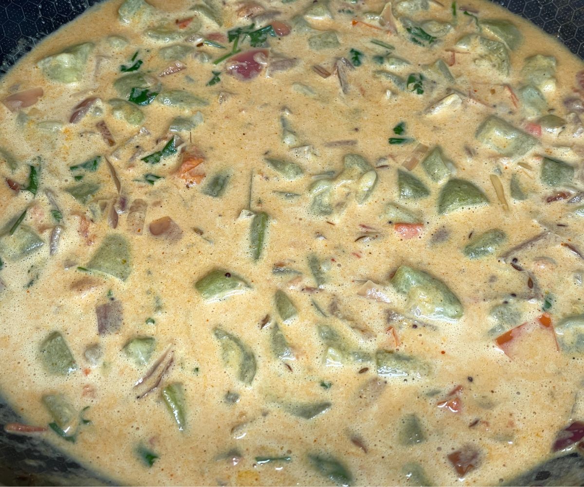 A pan has beerakaya curry over heat.