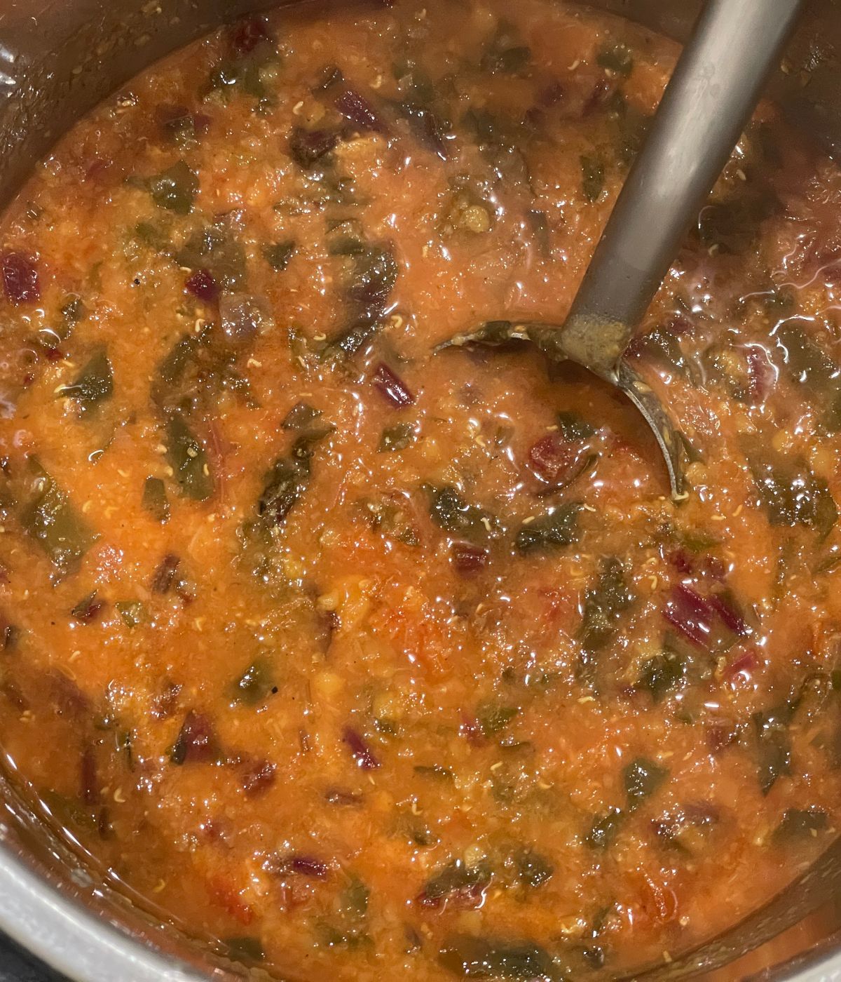 An Instant pot has beetroot leaves dal.