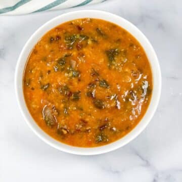 A bowl of beet greens dal is on the surface.