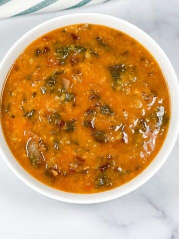 A bowl of beet greens dal is on the surface.