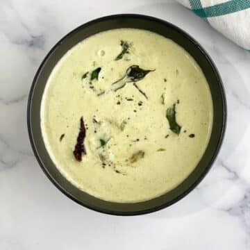 A bowl of doddapatre tambuli is on the surface.