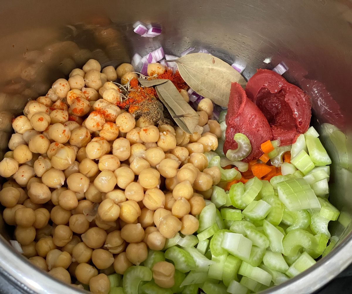 An instant pot has all the ingredients for garbanzo bean soup.