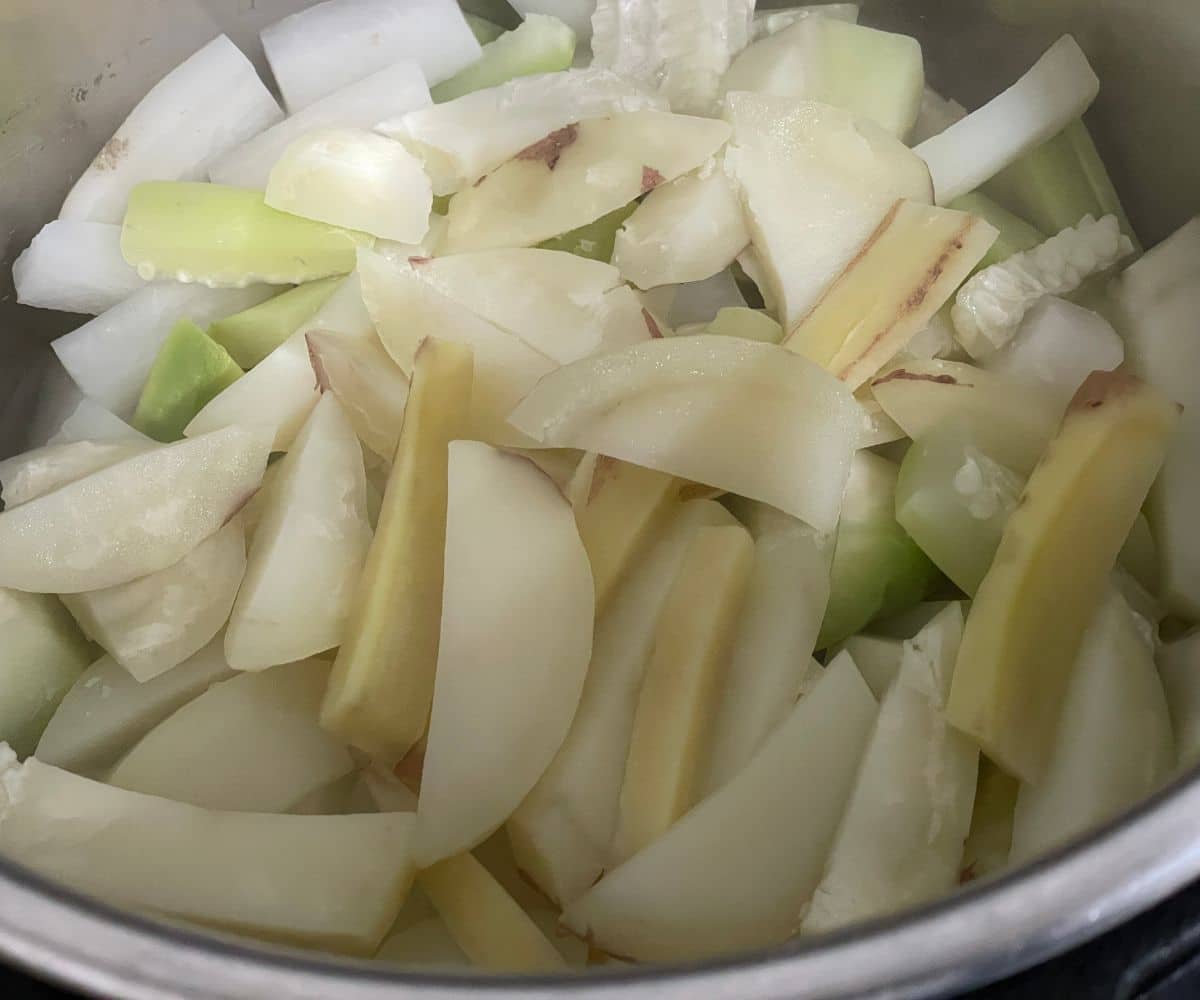 An instant pot has cooked vegetables.