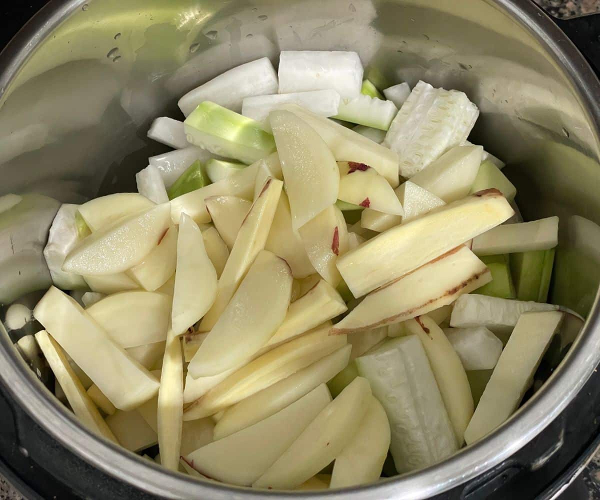 An instant pot has mixed vegetables.