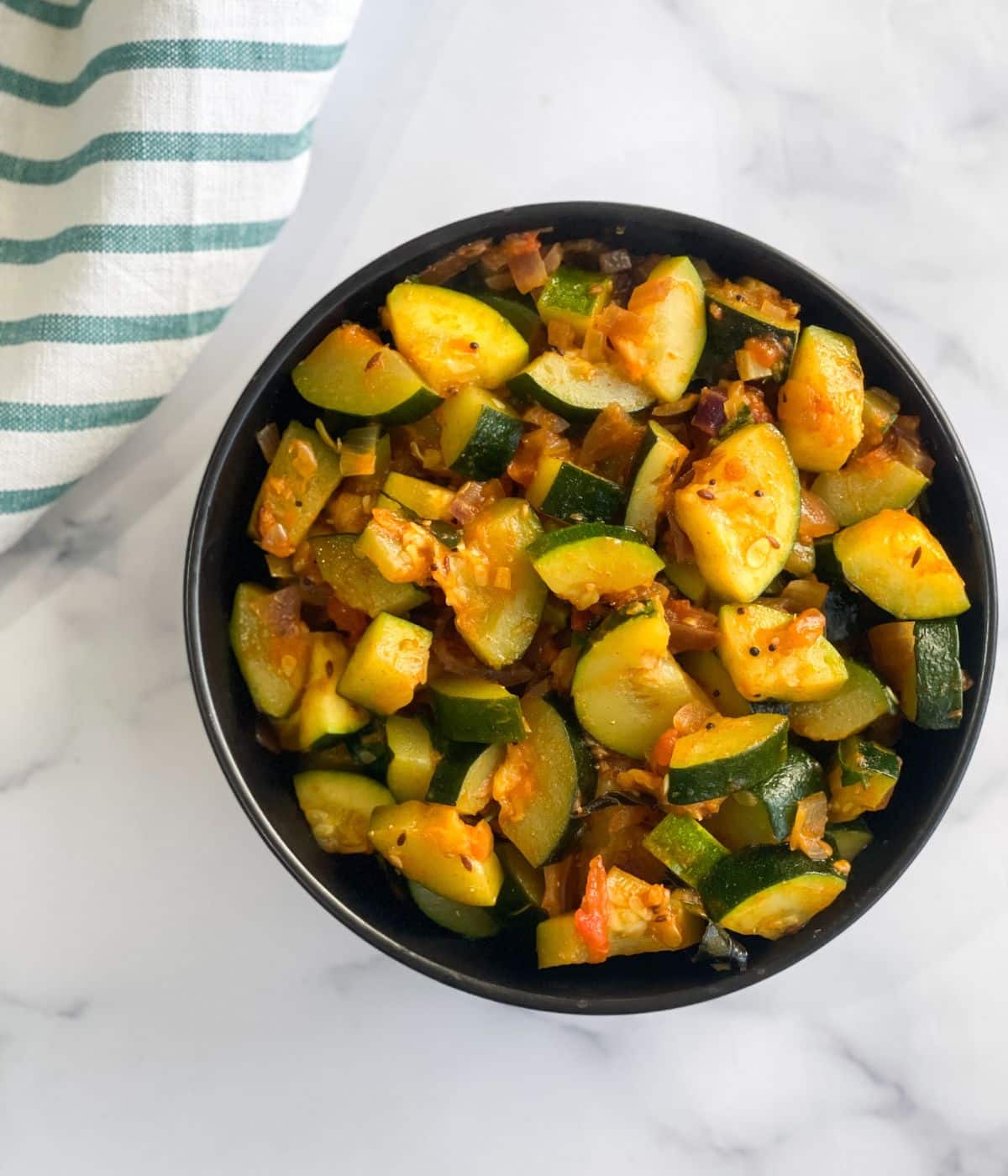 A bowl is full of zucchini sabzi.