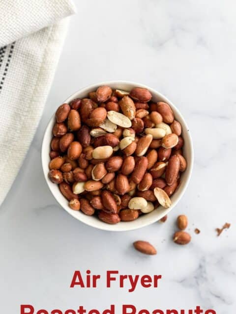 A bowl of roasted peanuts are on the surface.