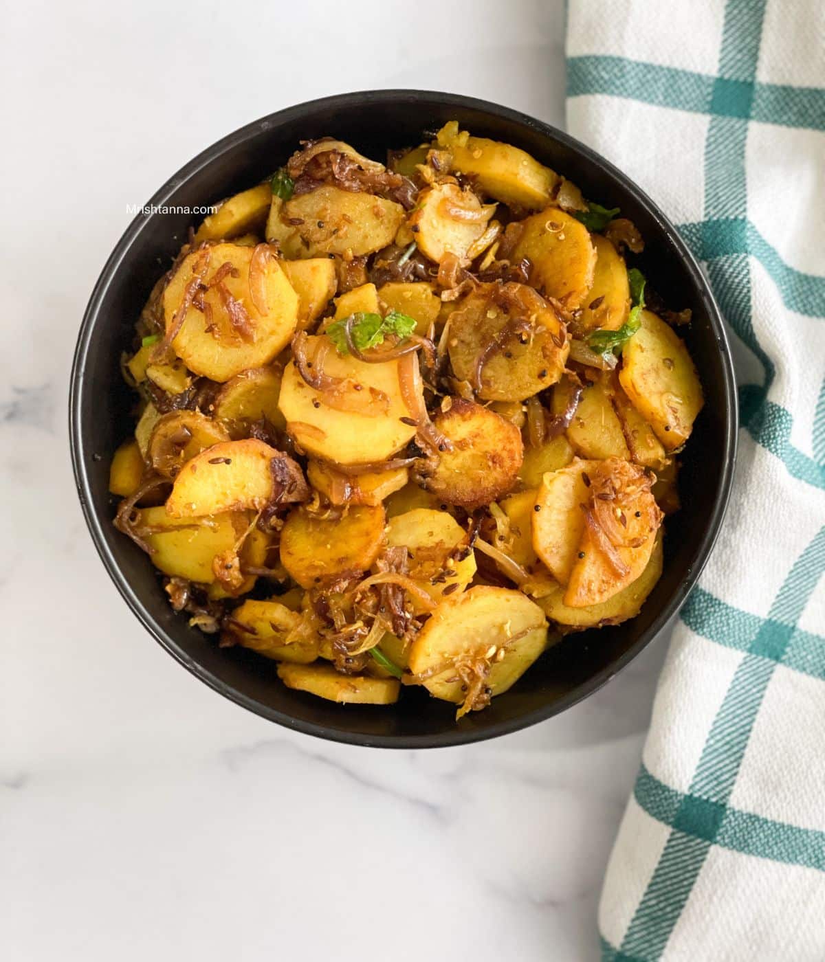A bowl is full of sweet potatoes stir fry.