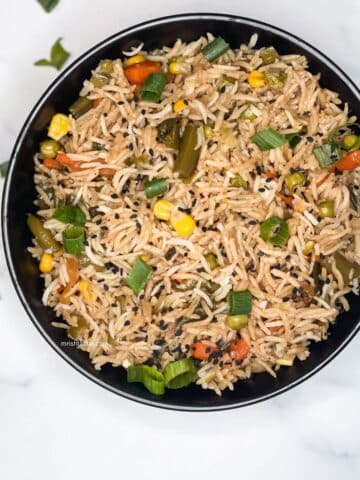 A bowl filled with vegetable basmati fried rice.