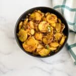 A bowl of sweet potato Indian recipe is on the table.